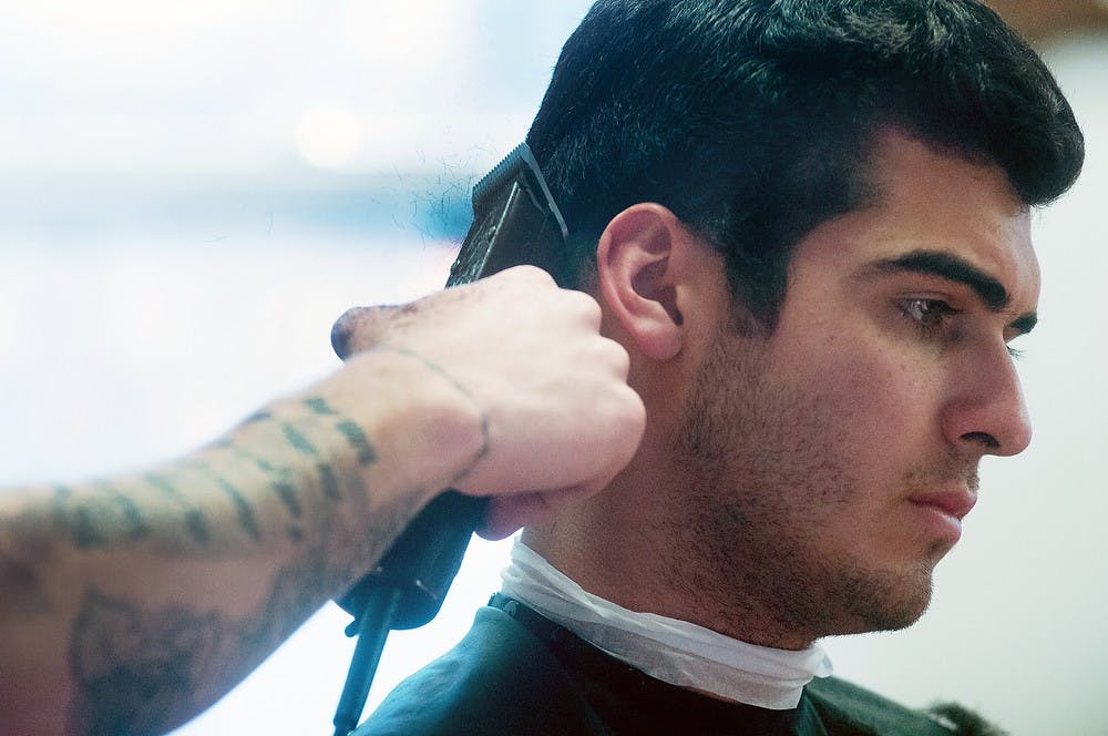 	<p>Human biology sophomore David Cassavar gets his hair cut on Jan. 21, 2014, at Grand River Barber Company. The company has seen more business during the spring semester due to a marketing effort made over winter break. Betsy Agosta/The State News</p>