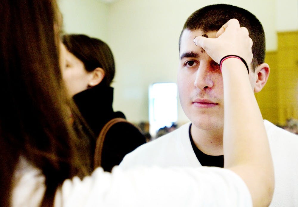 Sophomore finance student Michael Viselli receives an ash cross on his forehead Wednesday at St. John Church and Student Center, 327 M.A.C Ave. Ash Wednesday is observed as a day of fasting, abstaining from meat and repentence. Jaclyn McNeal/The State News