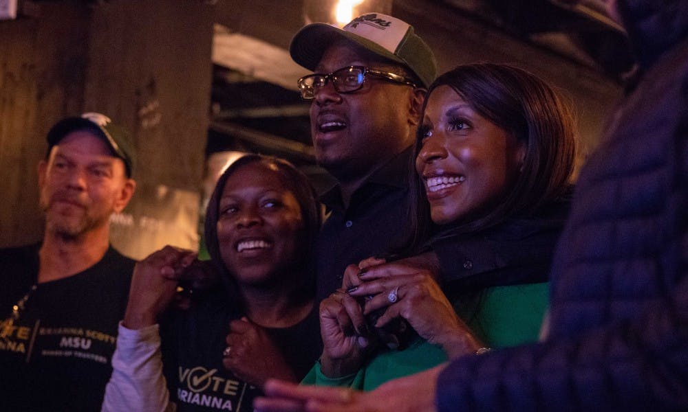<p>Newly-elected Trustee Brianna Scott watches results come in at her watch party with friends and family at Smash Wine Bar and Bistro in Muskegon, Nov. 6.&nbsp;</p>