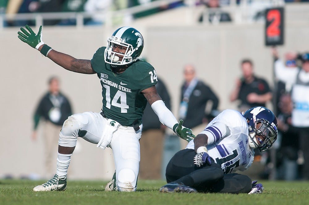 	<p>Sophomore wide receiver Tony Lippett looks confused after Northwestern defensive back Daniel Jones applied pressure on his previous play. The Spartans fell to the Wildcats, 23-20, Nov. 17, 2012, at Spartan Stadium during Senior Day. Justin Wan/The State News</p>