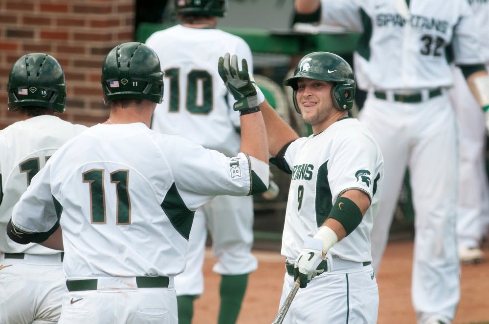	<p>Sophomore outfielder Jimmy Pickens, 9, celebrates with sophomore catcher Blaise Salter, 11, after Salter hit a home run on May 3, 2013, during the baseball game against the University of Illinois at McLane Baseball Stadium at Old College Field. The Spartans won 12-3. Julia Nagy/The State News</p>