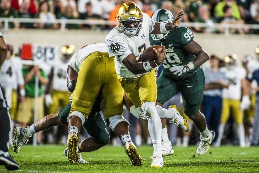 <p>Notre Dame quarterback Brandon Wimbush (7) runs the ball up the field during the game on Sept. 23, 2017 at Spartan Stadium. The Spartans fell to the Fighting Irish, 38-18.&nbsp;</p>