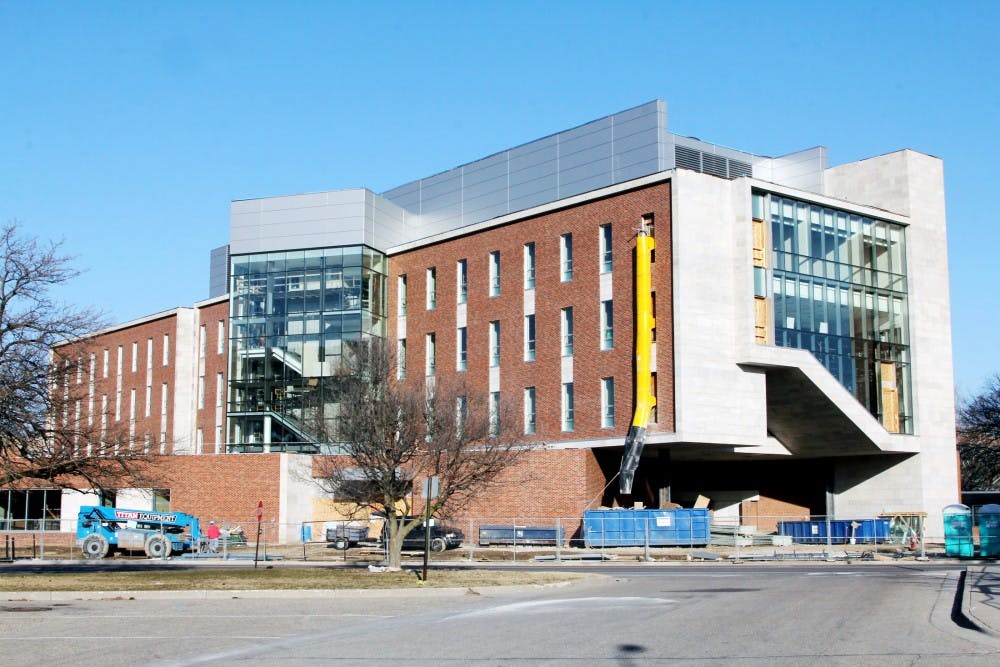 Progress continues Tuesday on the construction site at Wells Hall. The new addition to the building appears to be on track and should be mostly complete by the end of May. Derek Berggren/The State News