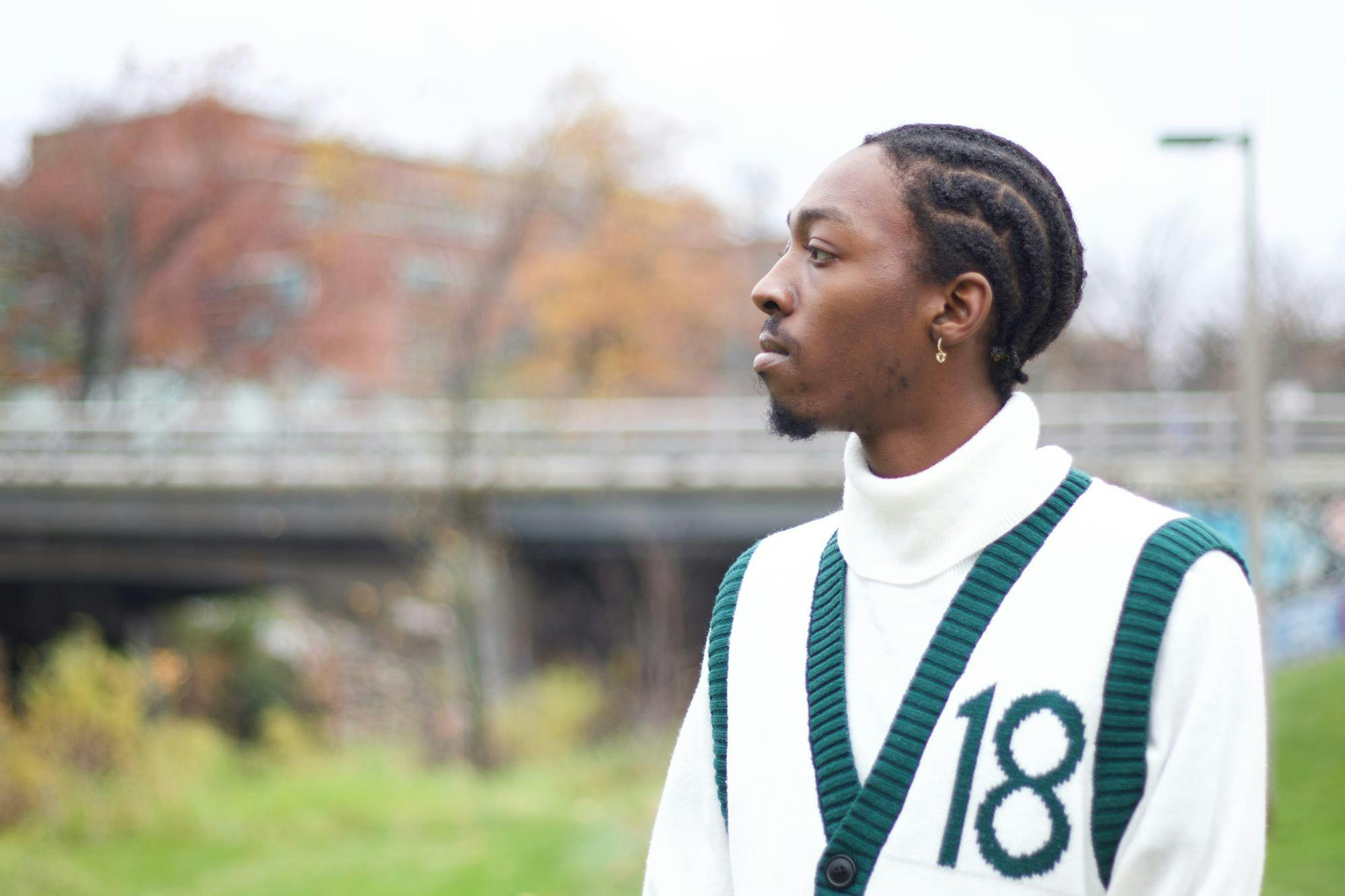 Junior Mikeise O. May stands by the Red Cedar River on Nov. 8, 2023, telling his story about being arrested last year. 