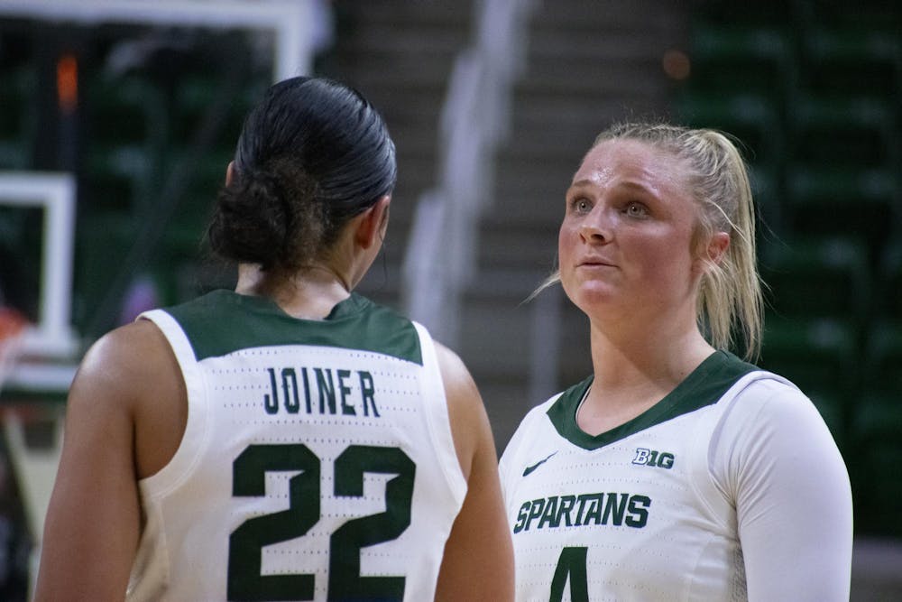 Michigan State University sophomore guard Theryn Hallock (4) and graduate guard Moria Joiner (22) strategize the next play during a game against Nebraska at the Breslin Center on Dec. 9, 2023. The Spartans lost to the Cornhuskers 74-80. 