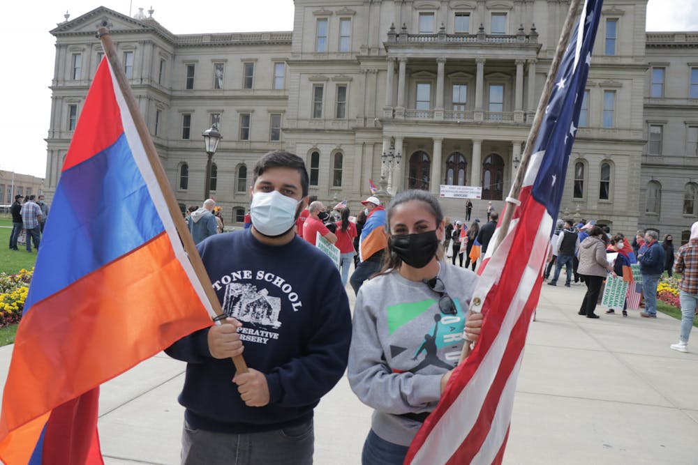 <p>East Lansing Mayor Aaron Stephens and Michigan State Rep. Mari Manoogian stand in support of Armenia at the Capitol on Oct. 11, 2020.</p>