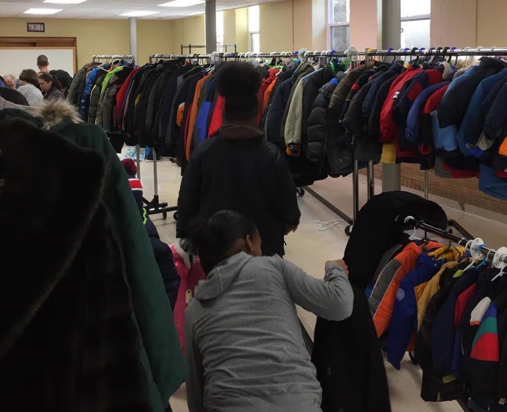 <p>Community members browse through winter coats and apparel at St. Luke Lutheran Church. The church offers the apparel for free to children and adults in the Lansing area. <strong>Photo courtesy of St. Luke Lutheran Church.</strong></p>