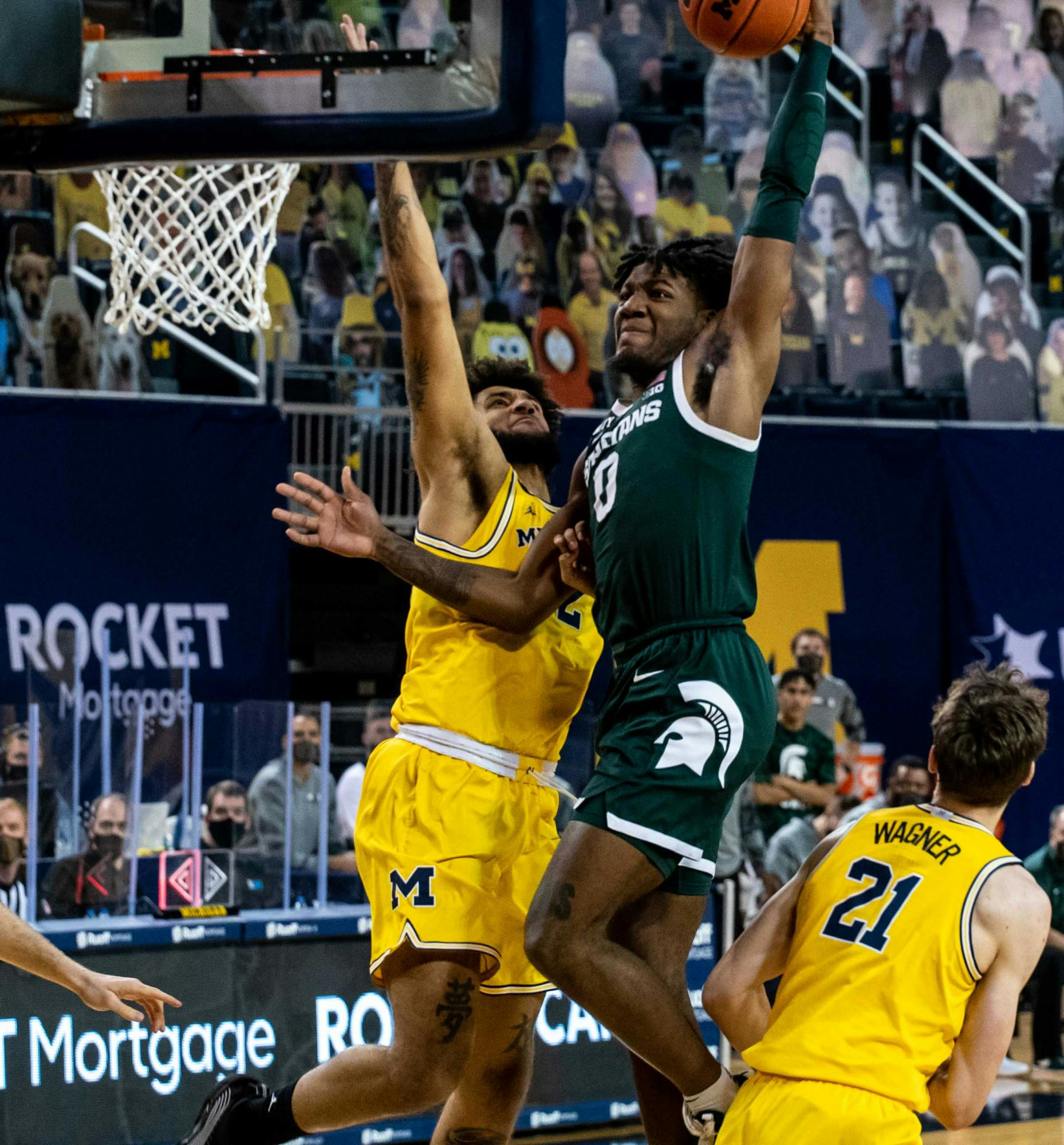 <p>Junior forward Aaron Henry (0) makes the first basket for Michigan State in the first half of the game. The Wolverines crushed the Spartans, 69-50, at Crisler Center on March 4, 2021.</p>