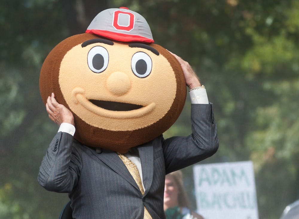 	<p><span class="caps">ESPN</span>&#8217;s Lee Corso puts on Brutus Buckeye mascot head on <span class="caps">ESPN</span> College GameDay broadcast on Saturday, Sept. 29, 2012 near Beaumont Tower. Despite picking <span class="caps">MSU</span> for going to the Rose Bowl, Corso did not favor <span class="caps">MSU</span> to win the game against the Ohio State on Saturday. Justin Wan/The State News</p>