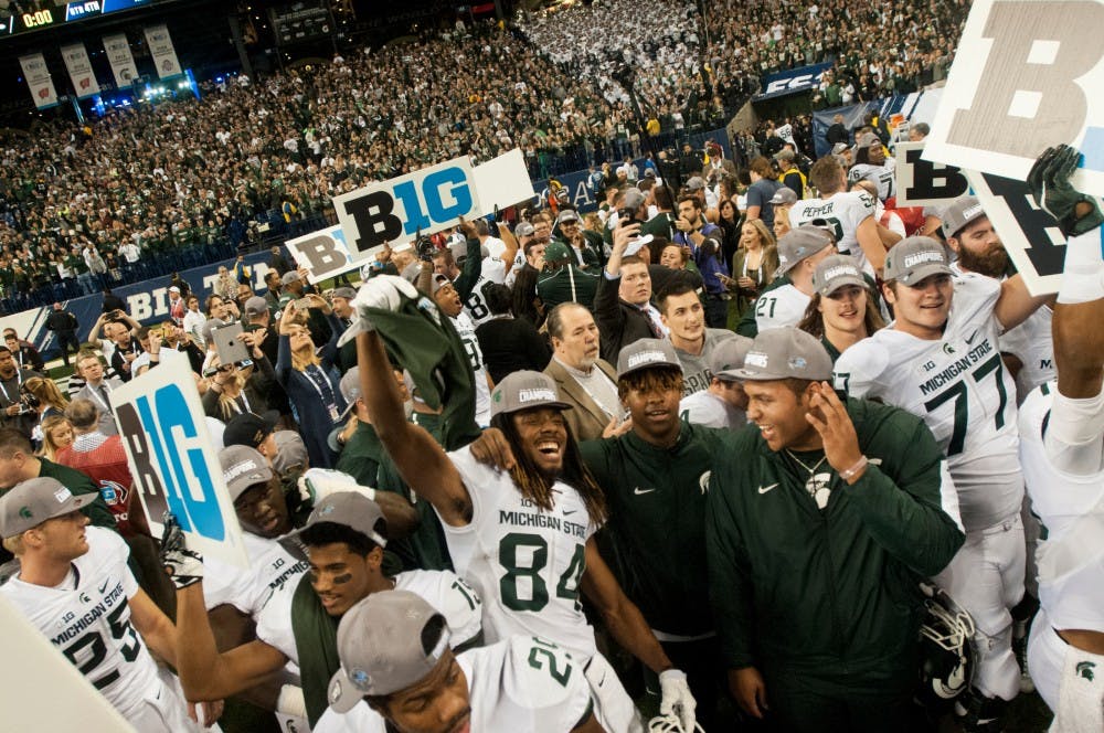 The Spartan football team and Spartan fans celebrate on Dec. 5, 2015 after the Big Ten championship game against Iowa at Lucas Oil Stadium in Indianapolis. The Spartans defeated the Hawkeyes 16-13.