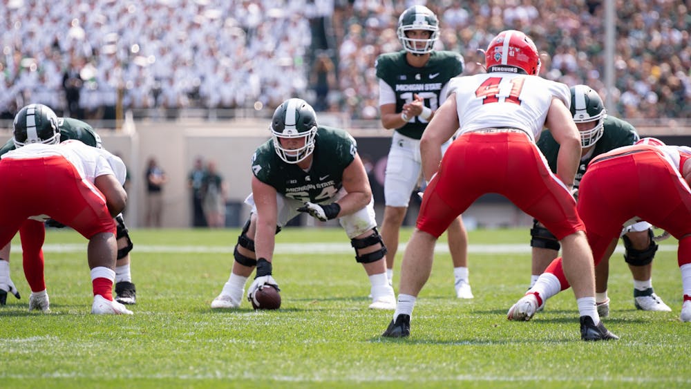 <p>Center, Matt Allen, prepares to snap the ball to quarterback, Payton Thorne, during the game against Youngstown State Sep. 11, 2021. The Spartans won the game against Youngstown State 42-14 at Spartan Stadium.</p>