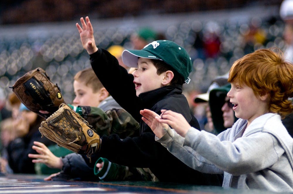 	<p>Huntington Woods residents Zack Vigliottti and Ryan Serwa, both 7, call for a ball Wednesday at Comerica Park in Detroit. Serwa and Vigliotti cheered on the Spartans as they defeated Central Michigan, 3-1, in the Clash at Comerica. Matt Radick/The State News</p>