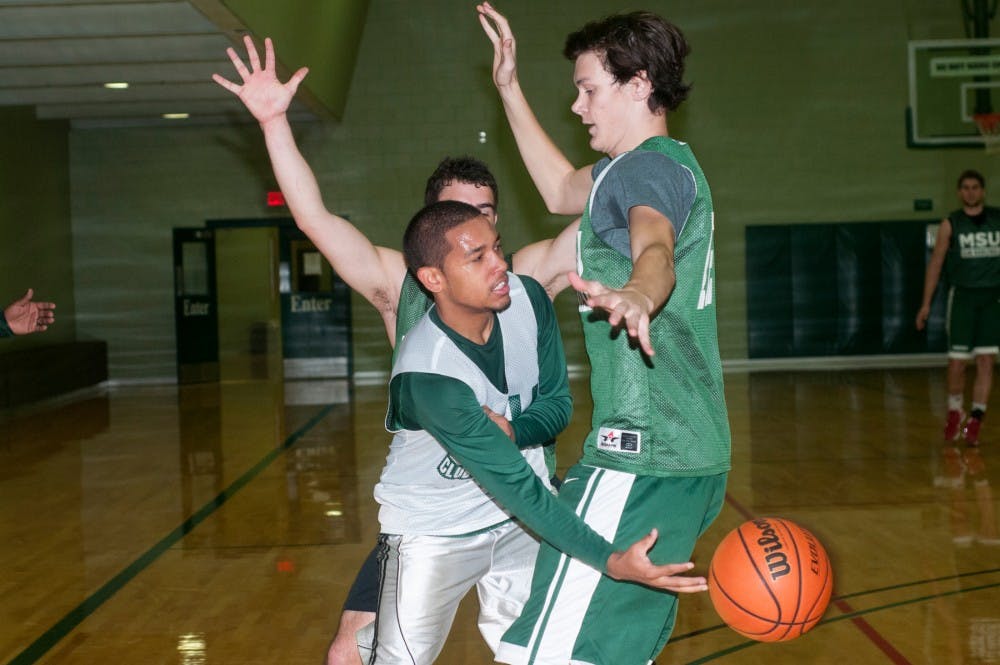 <p>First year medical student Robert Ray Jr. passes the ball during an MSU Club Basketball practice on Nov. 18, 2015 at IM Sports-East. The club, which competes with other universities around the state, was started this past semester and continues to grow. </p>