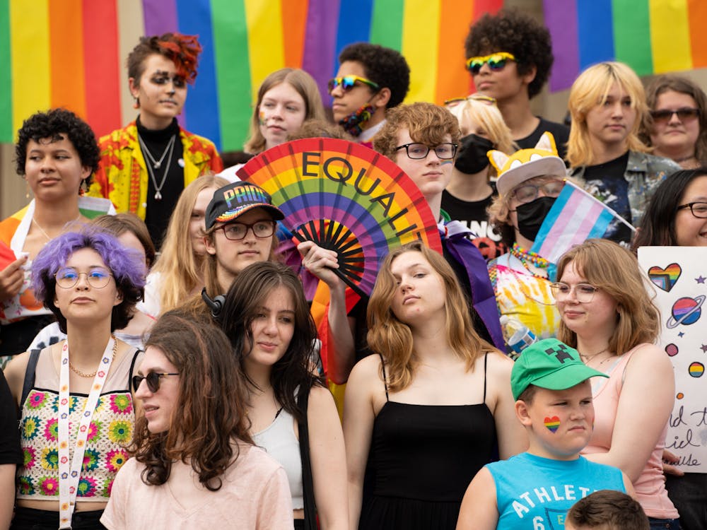 The youth attending the Lansing pride rally stand on the stairs of the capitol on June 26, 2022.