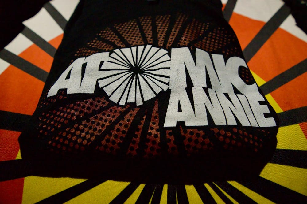 <p>Merch lies out on a table for Atomic Annie on Dec. 13, 2024 at Grewal Hall.</p>