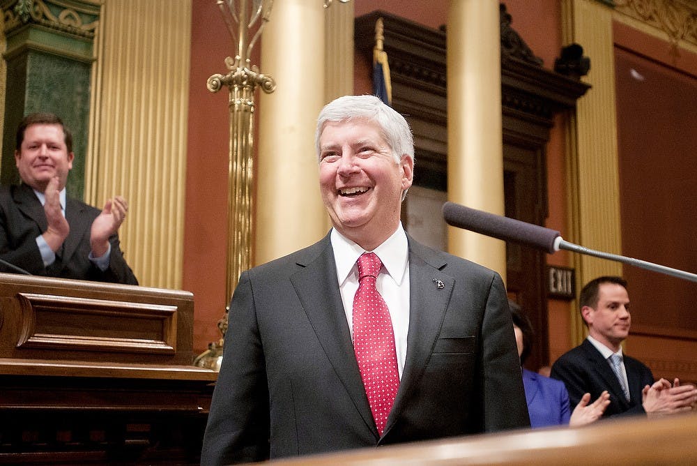 	<p>Gov. Rick Snyder smiles at the crowd before he begins his State of the State address on Wednesday, Jan. 16, 2013, at the Capitol Building.  Snyder informed the state of Michigan on all of the improvements that have been made in the past year, and his plans for the new year.  Katie Stiefel/ The State News</p>