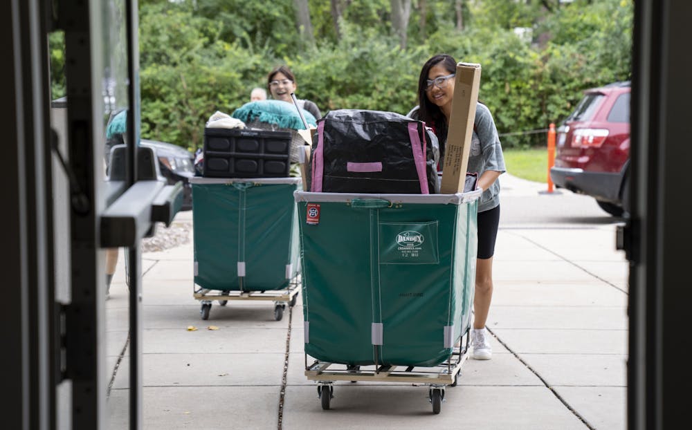 <p>Sakura Nothwehr helps her daughter, sophomore Mia Burghardt, move into Bailey Hall during Fall 2022 Move-In on Friday, Aug. 26, 2022 at Michigan State University.</p>