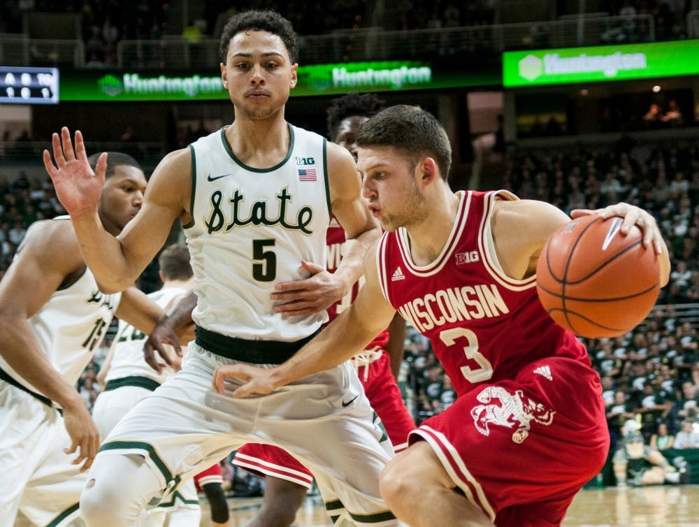 Senior forward Bryn Forbes defends Wisconsin guard Zak Showalter during the first half of the game against Wisconsin on Feb.18, 2016 at Breslin Center. The Spartans defeated the Badgers,
