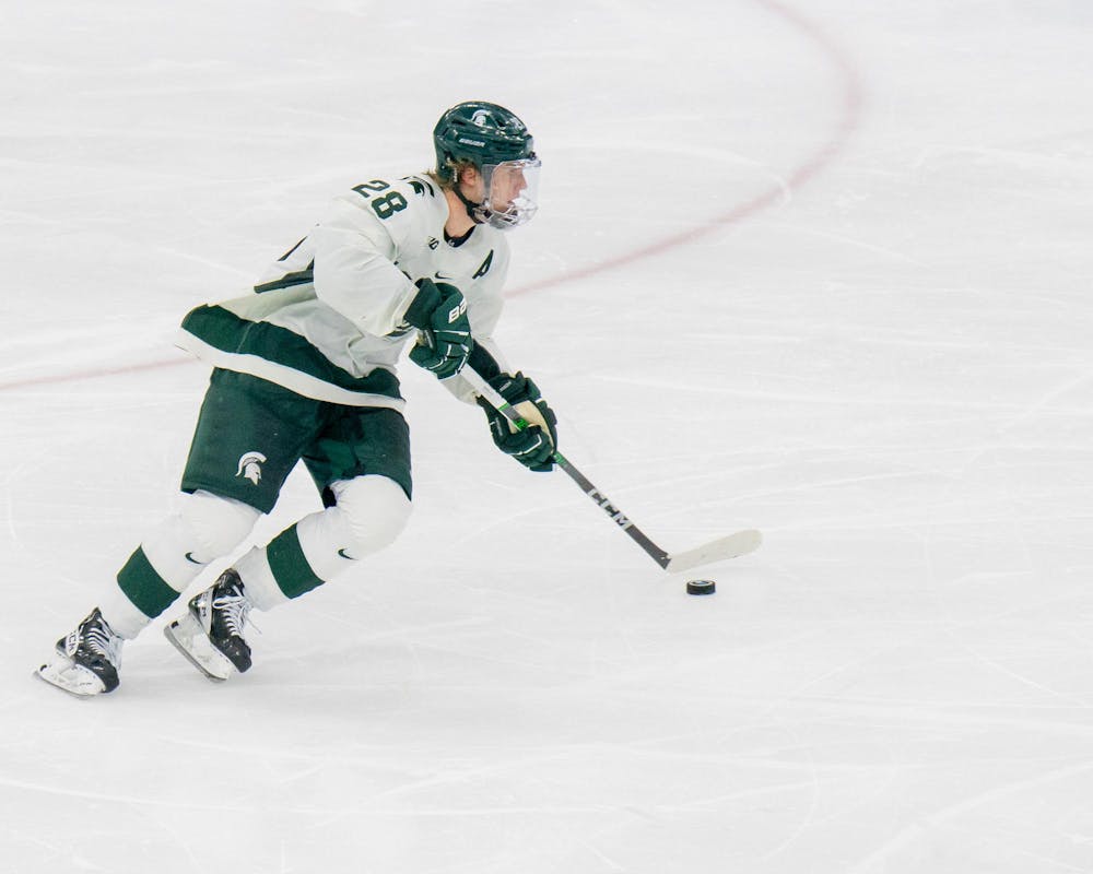 <p>Sophomore forward Karsen Dorwart (28) carrying the puck forward during a game against Ohio State University at Munn Ice Arena on Mar. 16, 2024.</p>