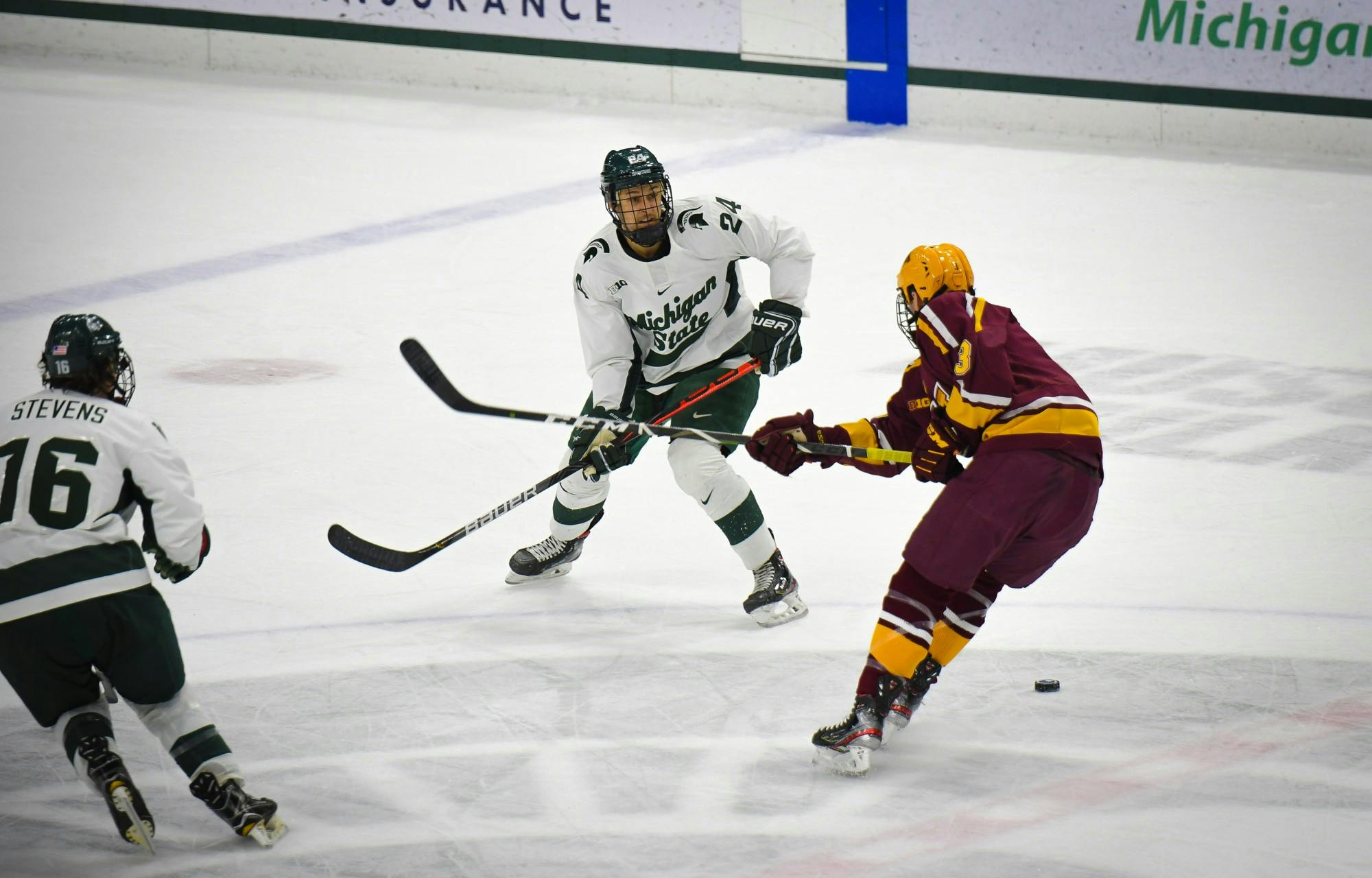 <p>Junior forward Austin Kamer (24) makes a pass during the hockey game against Minnesota at the Munn Ice Arena on Jan. 10. The Spartans defeated the Golden Gophers 4-1. </p>
