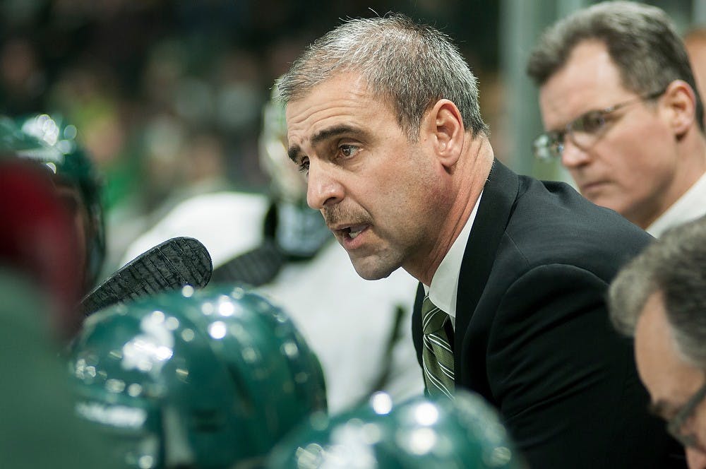 <p>Head coach Tom Anastos talks to players during a timeout in the game against Michigan on March 8, 2014, at Munn Ice Arena following two Michigan goals in the first period. Danyelle Morrow/The State News</p>