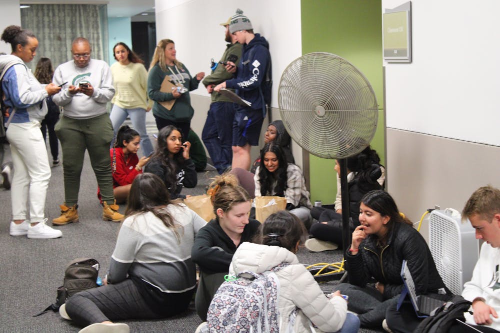 <p>Michigan State University students wait in line to vote in the 2022 midterm elections at the East Lansing City Clerk satellite office at Brody Hall. Some students reported waiting over four hours in line to cast a vote.</p>
