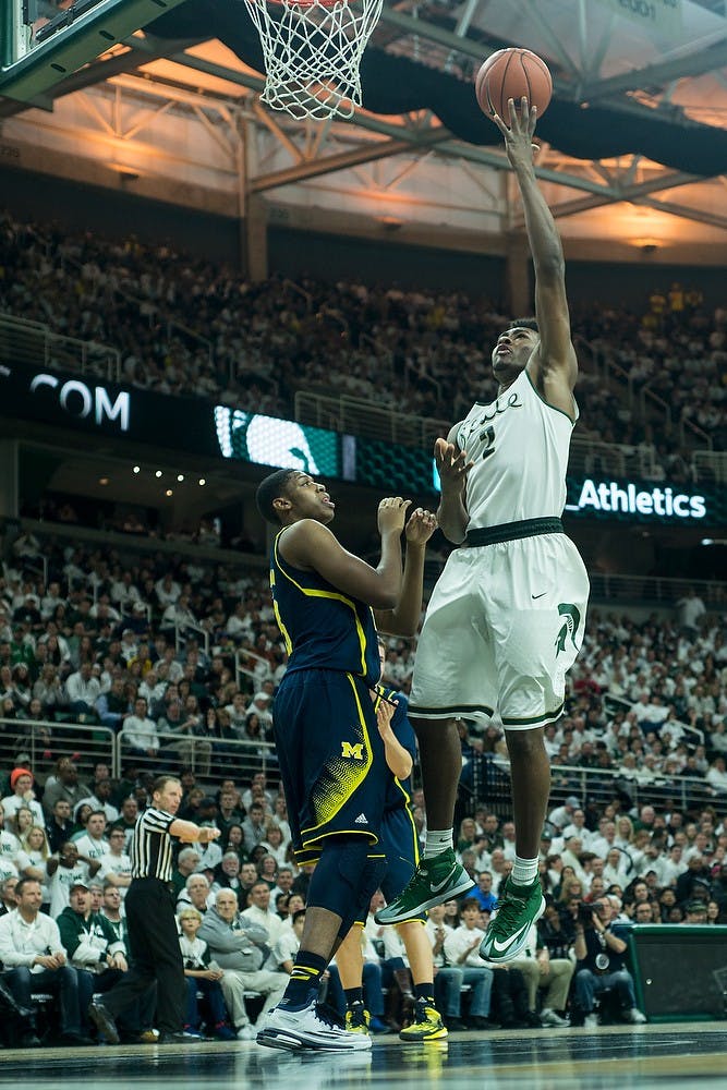 <p>Freshman forward Javon Bess attempts a point over Michigan guard forward Kameron Chatman Feb. 1, 2015, during the game against Michigan at Breslin Center. The Spartans defeated the Wolverines, 76-66. Erin Hampton/The State News</p>