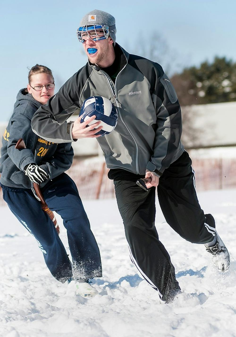 	<p>English junior, Nic Dziadosz runs with a ball as history education freshman Rachael Firehammer chases him during a practice drill Saturday, Feb. 9, 2013, at Munn Field. With the Harry Potter series recently ending, the Quidditch team is looking to maintain their popularity. Adam Toolin/The State News</p>