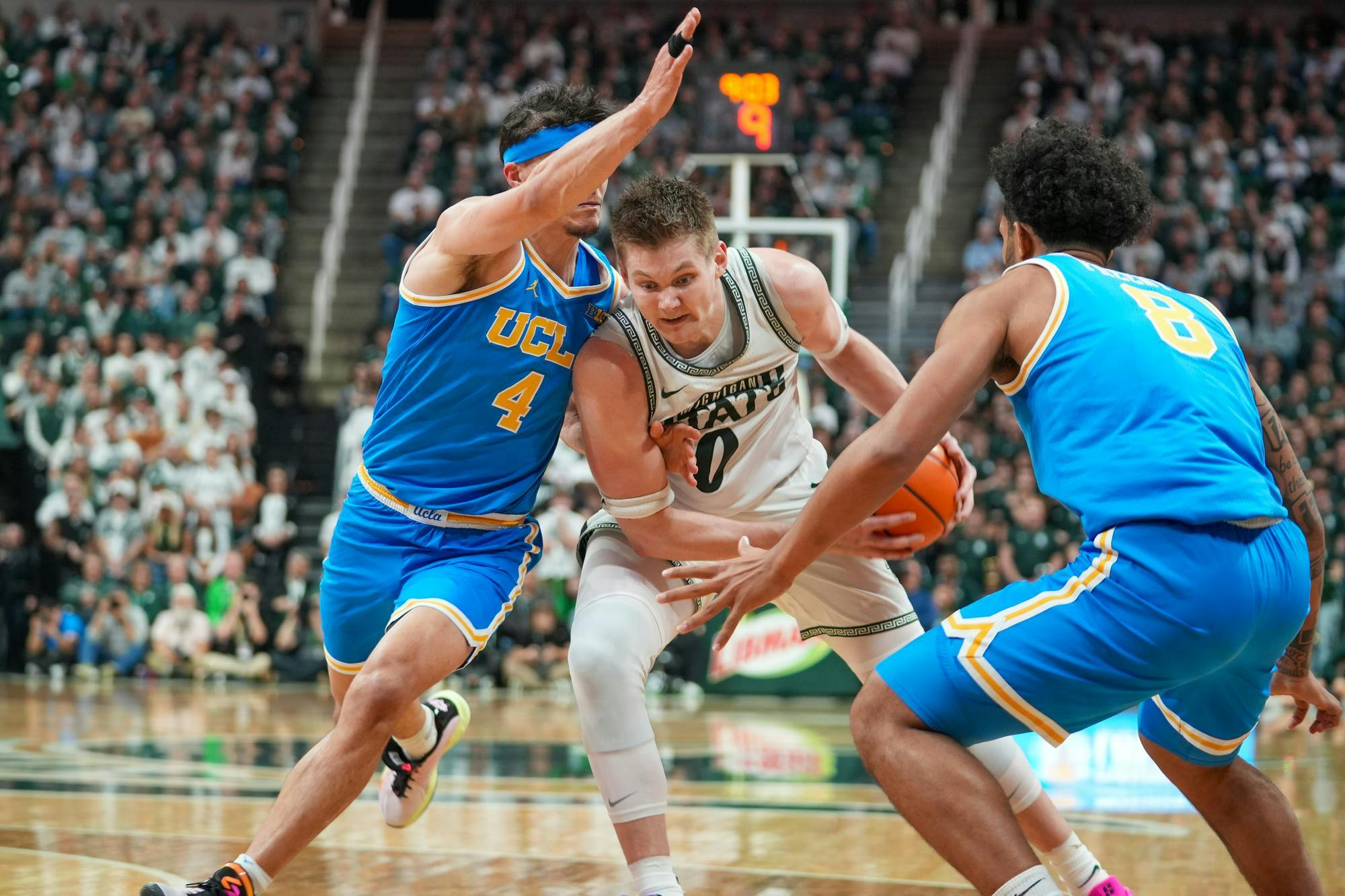 Michigan State senior forward Jaxon kohler (0) dribbles through contact against UCLA at the Breslin Center in East Lansing, Michigan, on Tuesday, Feb. 17, 2026.
