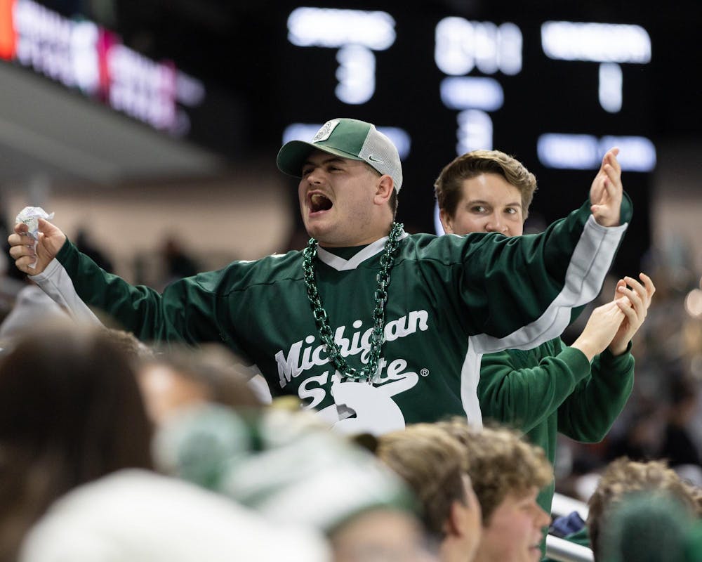 <p>An MSU hockey fan stands and cheers as his team wins and he finds out he won the 50/50 ticket in Munn Ice Arena in East Lansing, MI on Jan. 23, 2026.</p>