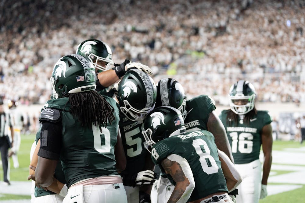 <p>Michigan State Football teammates Jalen Berger, Maliq Carr, and others celebrate during their game against Central Michigan on September 1st, 2023.</p>