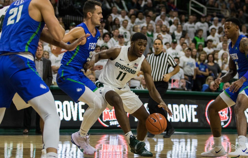 Freshman forward Aaron Henry (11) dribbles the ball during the game against Florida Gulf Coast University at Breslin Center on Nov. 11, 2018. The Spartans defeated the Eagles, 106-82.