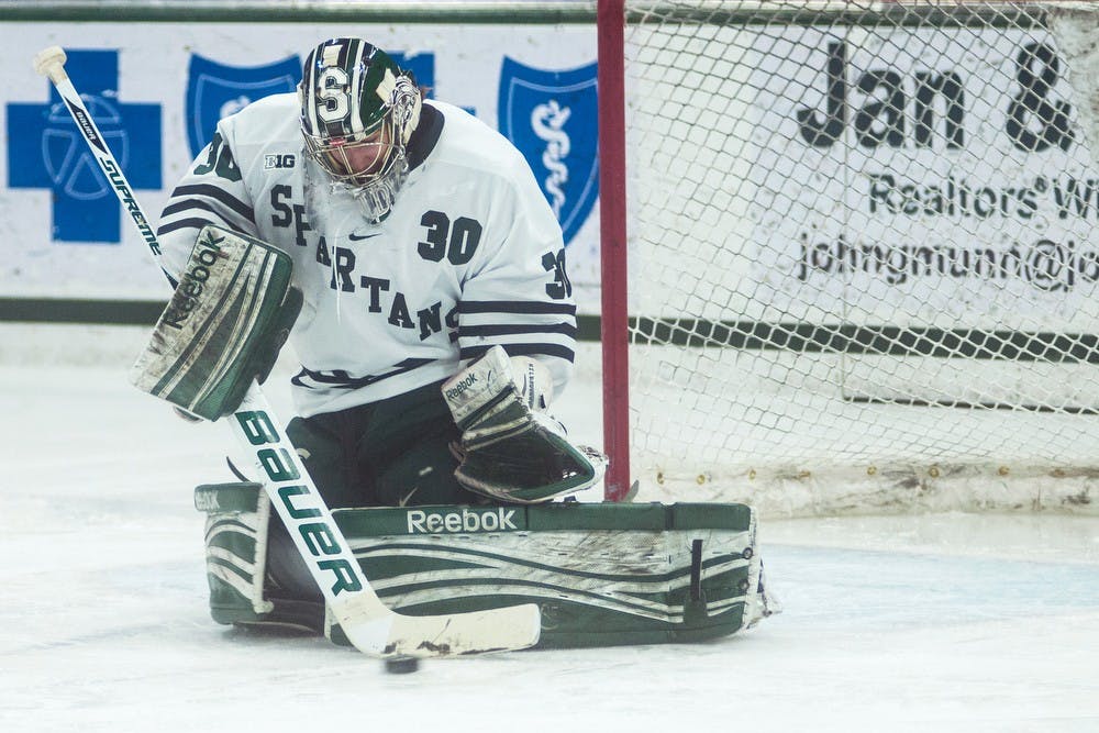 	<p>Sophomore goaltender Jake Hildebrand blocks the puck Jan. 24, 2014, at Munn Ice Arena during the game against Michigan. The Wolverines defeated the Spartans, 5-2. Erin Hampton/The State News</p>