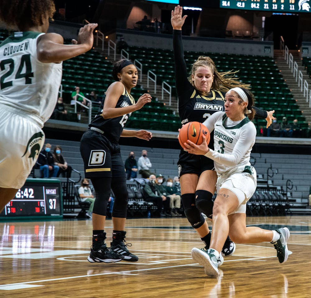 <p>Junior guard Alyza Winston (3) runs the ball up to the Michigan State basket in the third quarter. The Spartans crushed the Bulldogs, 100-60, which led coach Suzy Merchant to her 300th win with Michigan State on Nov. 19, 2021.</p>
