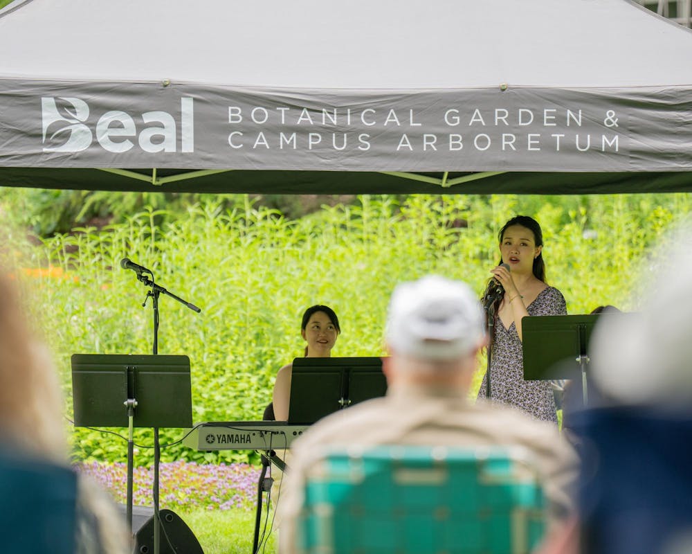 <p>An MSU Go Music Trio member Zimo Chen talks to crowd about the music they will perform during the Music and the Garden event in East Lansing, Mich., on June 28, 2026.</p>