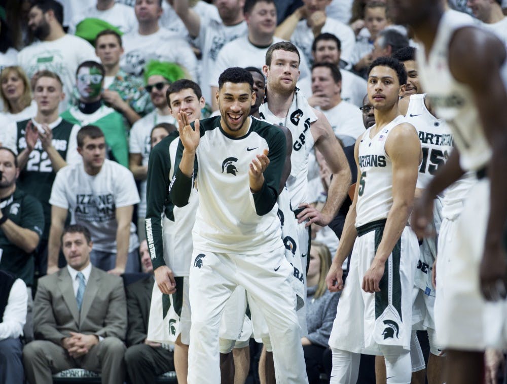 Senior guard Denzel Valentine revels in excitement as sophomore guard Greg Roy enters the second half of the game against Illinois on Jan. 7, 2016 at Breslin Center. The Spartans defeated the Illini 79-54.