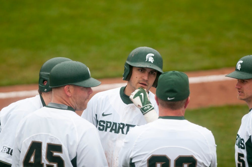 Players chat during a break  during the game against Central Michigan University on March. 23, 2016 at McLane Stadium. The Spartans defeated the Chippewas, 4-1.
