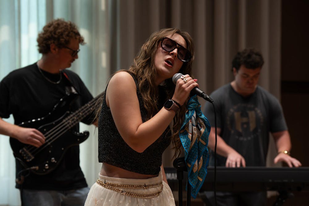 <p>Roxy Riot, MSU student band, members Kade Ringer, Alina Morse and Kyle Quick (from left), practice at the MSU Music Building in East Lansing, Mich., on July 17, 2026.</p>