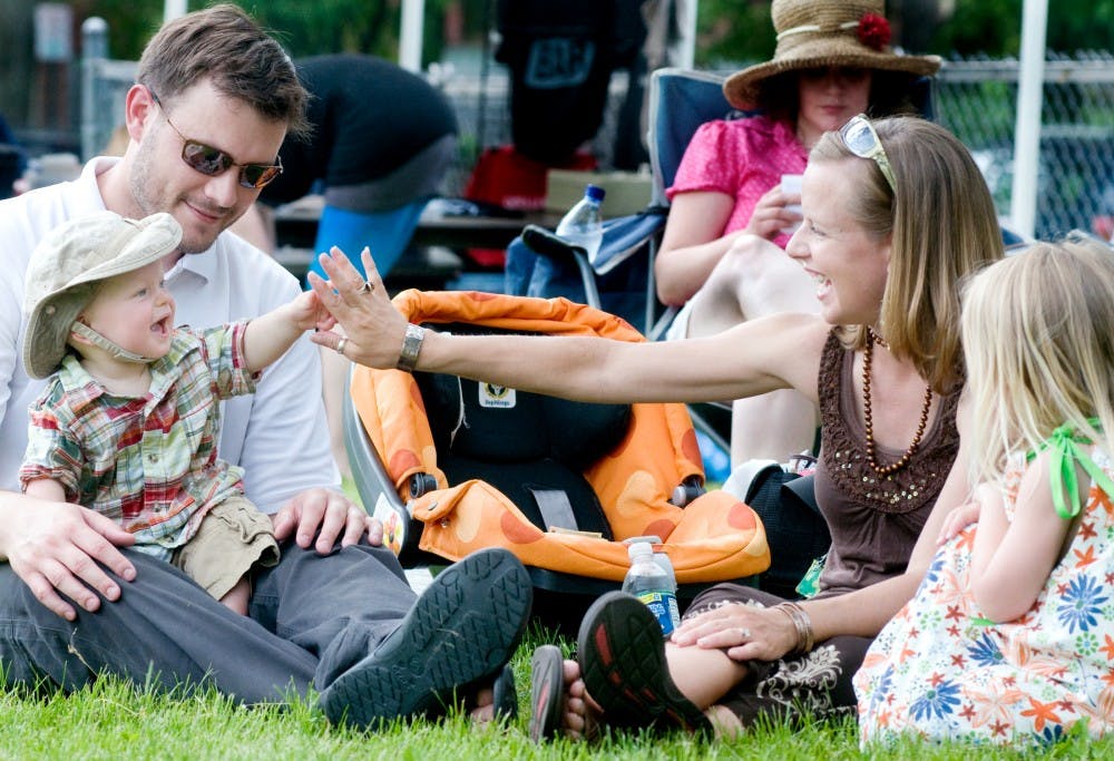 	<p>The Irwin family are in high spirits on Saturday at Pumpstock 2011. Brian, left, and Rachel, right, share a moment with their children Ezra, 9 months, and Ailynn, 3. </p>