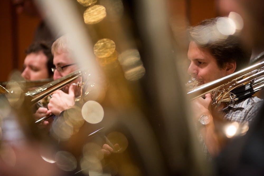 Music education senior Aaron Wright plays the trombone in the Wind Symphony during a rehearsal on Sept. 30, 2015, in Wharton Center's Cobb Great Hall. The group was rehearsing for a concert featuring David Maslanka's music on Oct. 1 at 7:30 p.m. in Wharton Center's Cobb Great Hall.