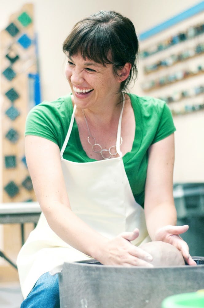 East Lansing resident Jenna Neal works on a vase during a ceramics class on Monday, August 6, 2012 at the Bailey Community Center, 300 Bailey St. "I just thought it would be something fun to learn," Neal said. Julia Nagy/The State News