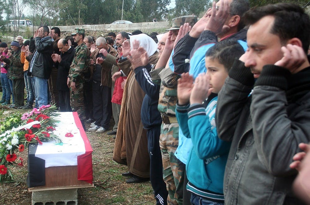 	<p>Mourners pray over the coffin in Tartous, Syria, of Ibrahim Yeya Issa, a 32-year-old Army soldier killed fighting Islamist rebels, near his grave in an unused plot of city-owned land. So many young men from Tartous, which is fanatically loyal to President Bashar Assad, have been killed fighting in Syria&#8217;s civil war that there is no more room in the city&#8217;s cemetaries. (Jonathan S. Landay/MCT)</p>