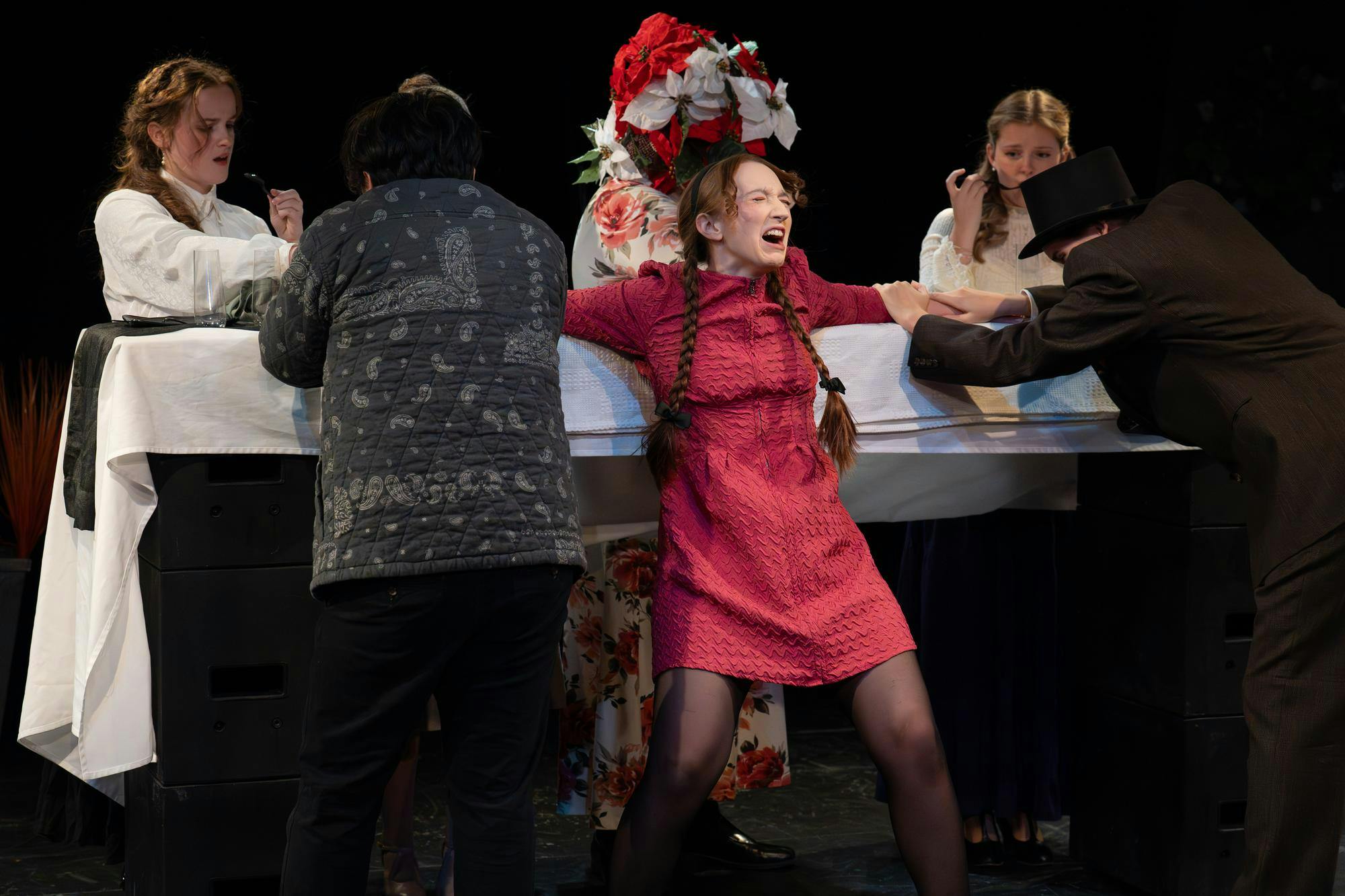 The cast of MSU’s Department of Theatre rehearses an energetic dinner scene during their dress rehearsal of Chemical Imbalance: A Jekyll and Hyde Play, as Chamang Yang, playing Henry Jekyll, attempts to use Savannah Jordan’s character, Calliope, for a potion in East Lansing, Mich., on Monday, Nov. 17, 2025.