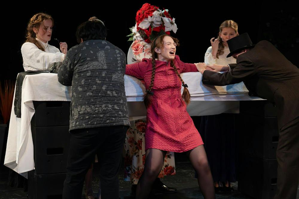 The cast of MSU’s Department of Theatre rehearses an energetic dinner scene during their dress rehearsal of Chemical Imbalance: A Jekyll and Hyde Play, as Chamang Yang, playing Henry Jekyll, attempts to use Savannah Jordan’s character, Calliope, for a potion in East Lansing, Mich., on Monday, Nov. 17, 2025.
