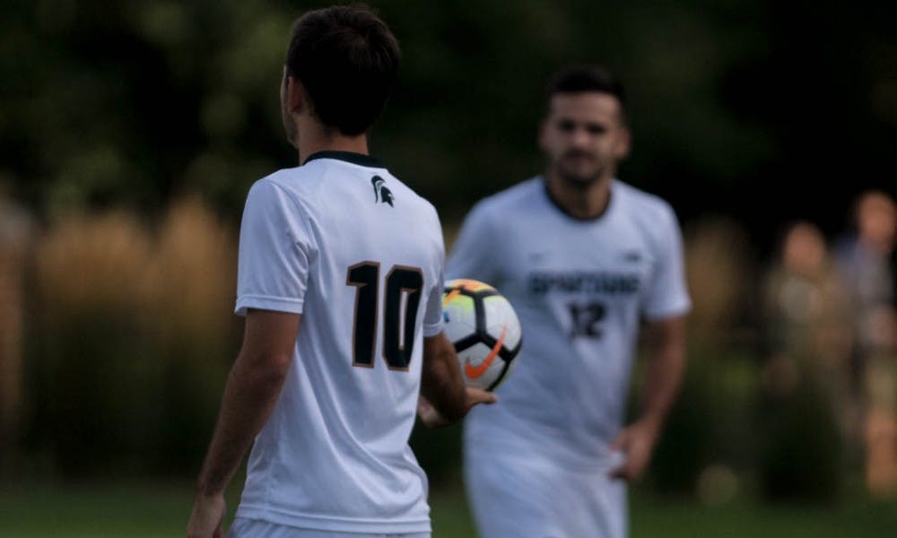 Sophomore midfielder Giuseppe Barone (10) hands off the ball to junior defender John Freitag (12) during a game against Dartmouth on Sep. 1, 2017 at DeMartin Stadium at Old College Field. The Spartans defeated the Big Greens 1-0.