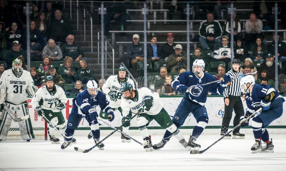 Senior wing Villiam Haag (26) attempts to find open space during the game against Penn State on Feb. 24, 2017 at Munn Ice Arena. The Spartans were defeated by the Nittany Lions, 4-2.