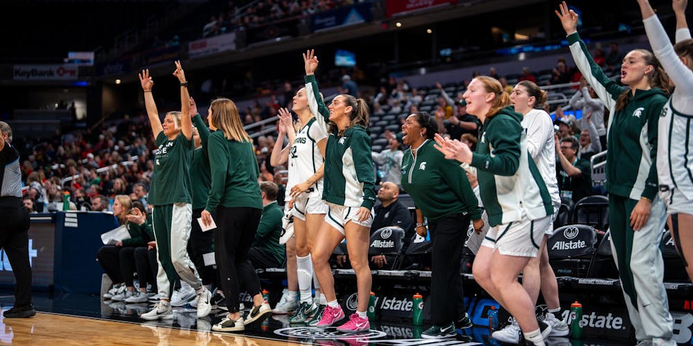<p>The MSU women's basketball team bench stands up as a 3-point shot is made in the Gainbridge Fieldhouse in Indianapolis, IN on March 5, 2026.</p>