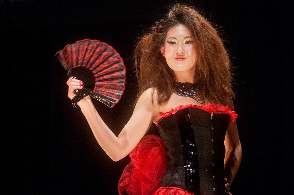 	<p>Communications senior Summer Yan poses at the end of the runway of the Pasant Theatre to model apparel and textile design junior Maria Estrada&#8217;s garment &#8220;Black Widow&#8221; on Sunday, March 24, 2013, during the Apparel and Textile Design Fashion Show. The show presented student creations based around sustainability and cultural dress. Danyelle Morrow/The State News</p>