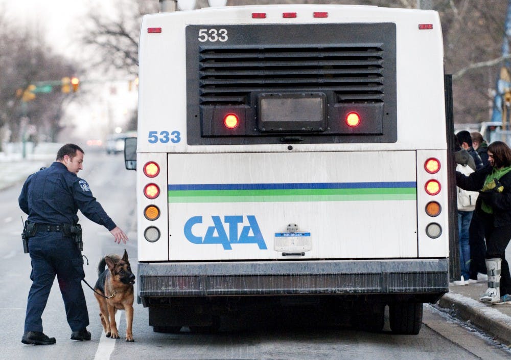 An MSU police K-9 unit  responds to reports of suspicious activity regarding a CATA bus on Friday afternoon along E. Grand River Avenue. Both MSU and East Lansing police shutdown the roadway as they evaluated the threat. Josh Radtke/The State News