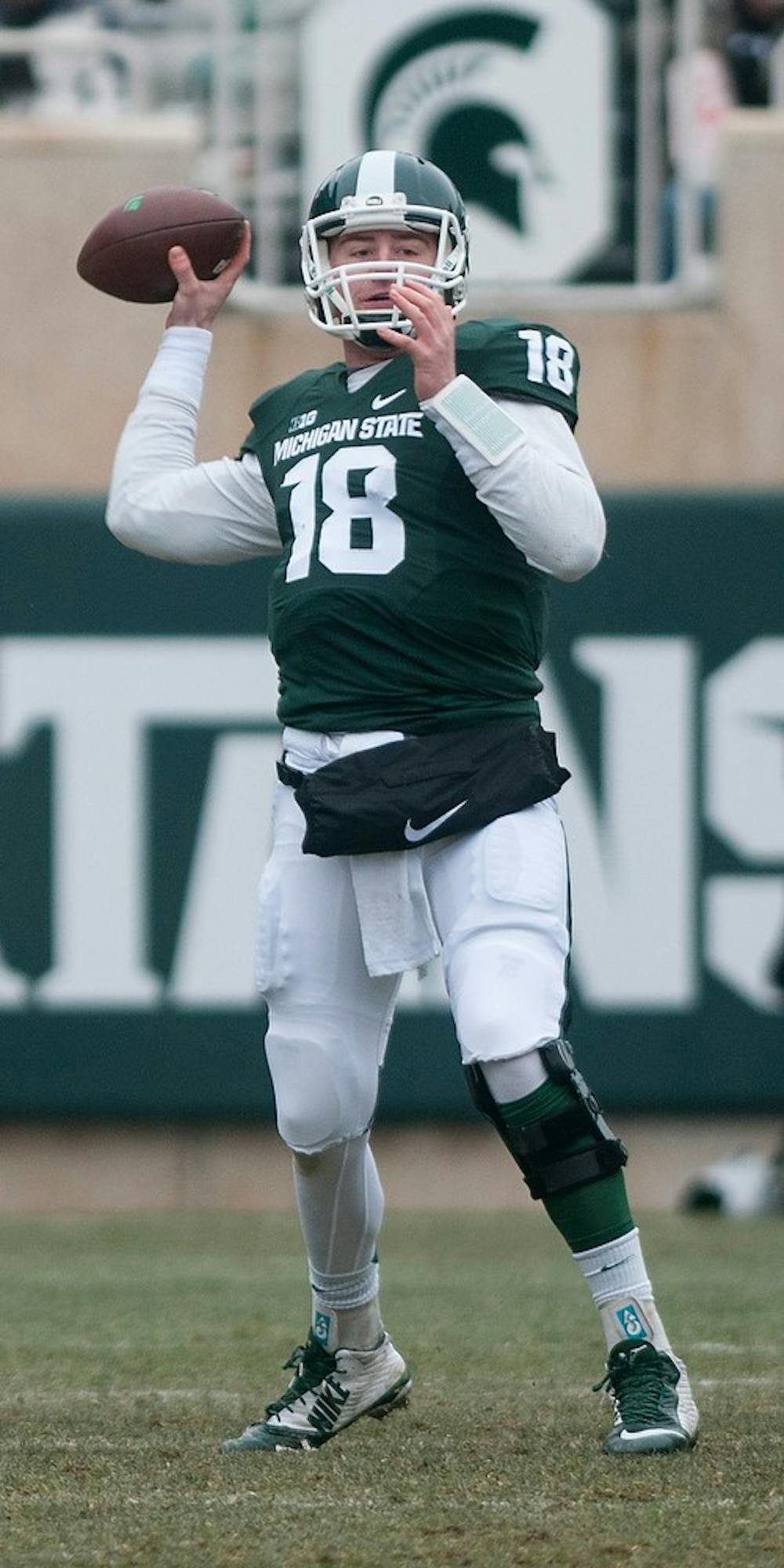 <p>Junior quarterback Connor Cook throws a pass Nov. 22, 2014, during the game against Rutgers at Spartan Stadium. Cook passed two touchdowns during the game. The Spartans defeated the Scarlet Knights, 45-3. Raymond Williams/The State News</p>